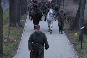 Zdjęcie przedstawia maszerujących żołnierzy, jeden z nich jedzie na koniu. (photo)